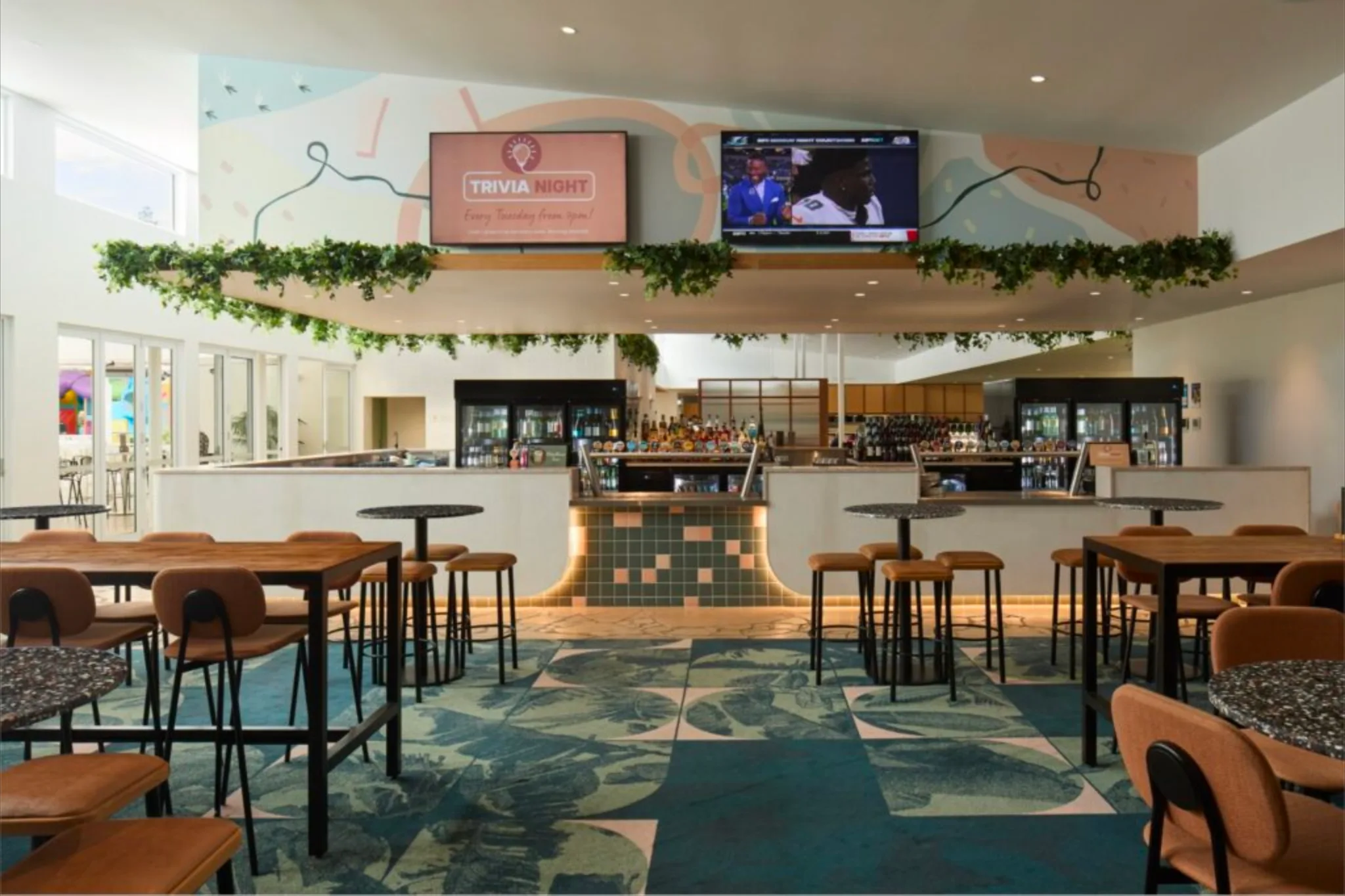 Bateau Bay Hotel's bar and dining area with its Tuesday Trivia Night screen