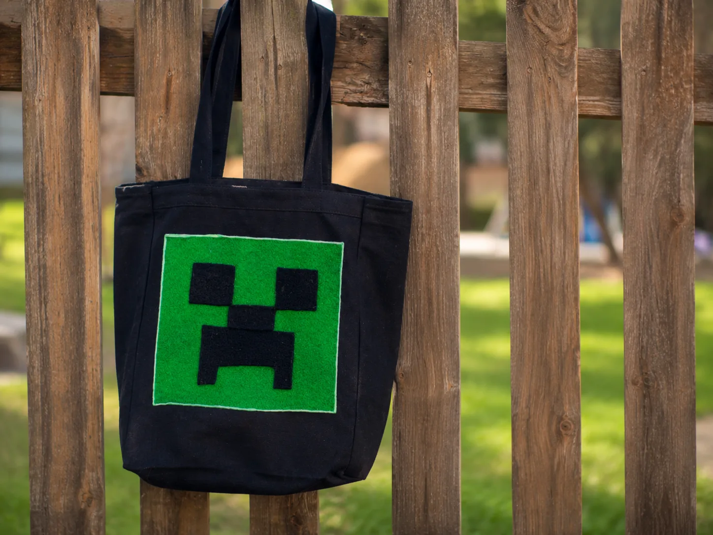 Minecraft-inspired felt Creeper design on a black tote bag