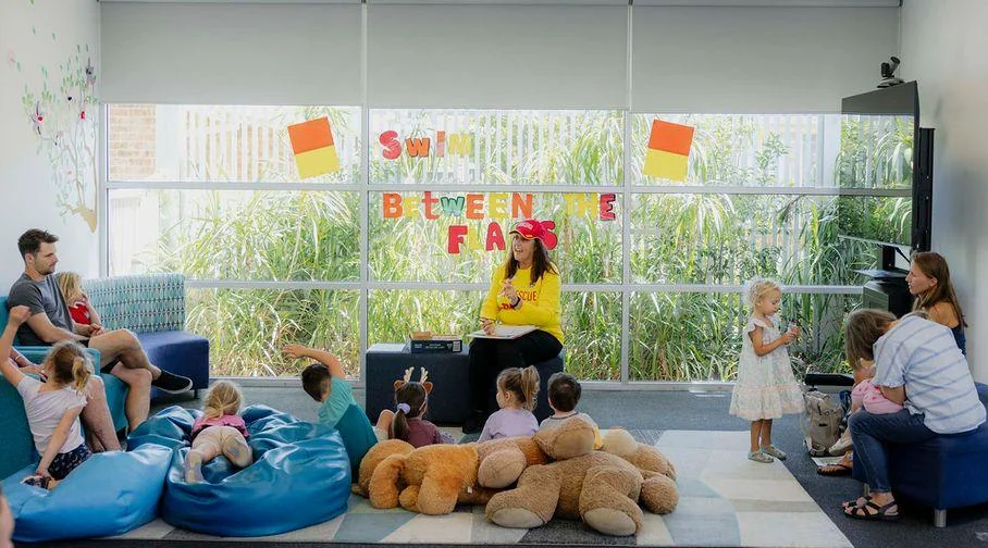 Young children and carers gathered for a water-themed library storytime